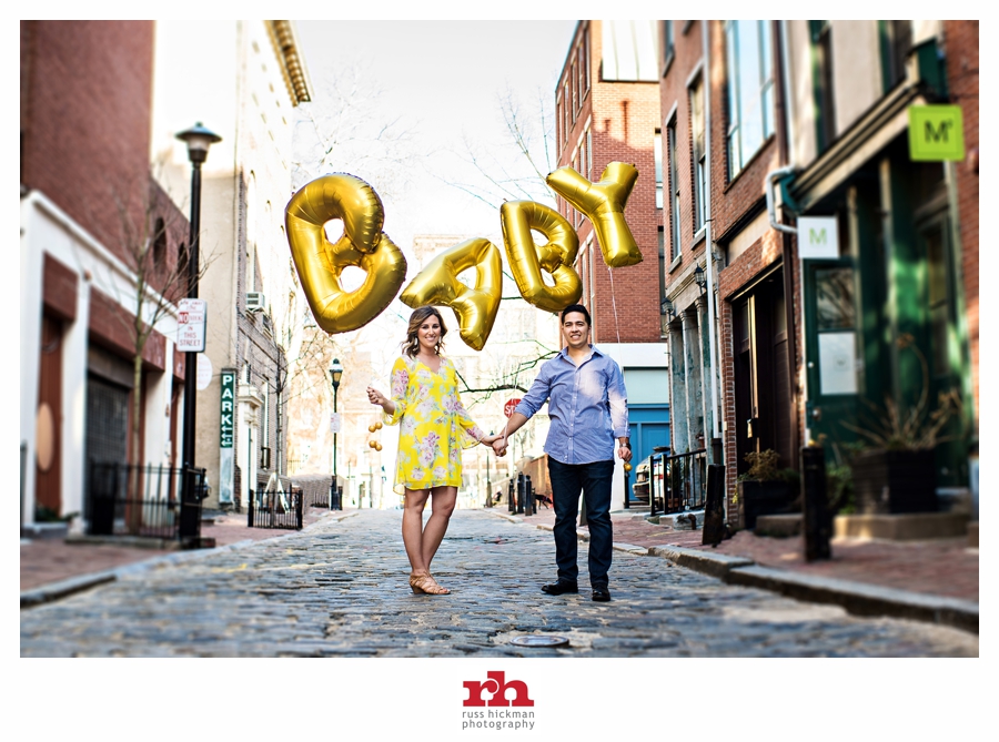 A Pregnant Couple walk with giant baby balloons in Philadelphia.